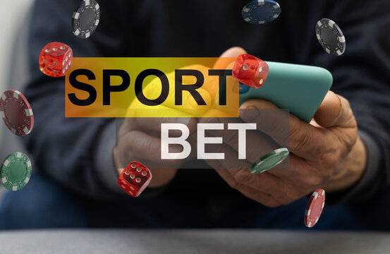 Man watching football play online broadcast on his laptop, cheering for his favourite team, making bets at bookmaker's website.