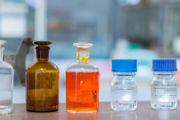 Laboratory glassware with green liquid in a science research laboratory.