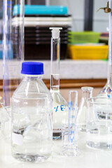 Laboratory glassware with green liquid in a science research laboratory.