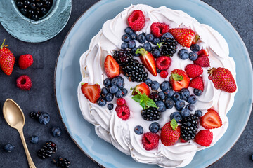 Mixed Berry Pavlova- A light and airy meringue base topped with a luscious cream filling and a medley of fresh berries, creating a visually stunning and delicious dessert.