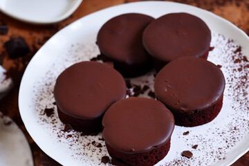 Chocolate Lava Cakes- Decadent, molten chocolate cakes with a gooey center, served warm and topped with a dusting of powdered sugar