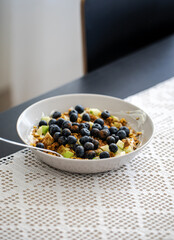 breakfast bowl with greek yoghurt, blueberries, granola and a diced apple, healthy fitness food breakfast