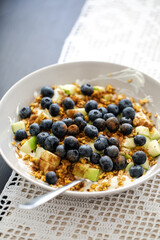 breakfast bowl with greek yoghurt, blueberries, granola and a diced apple, healthy fitness food breakfast