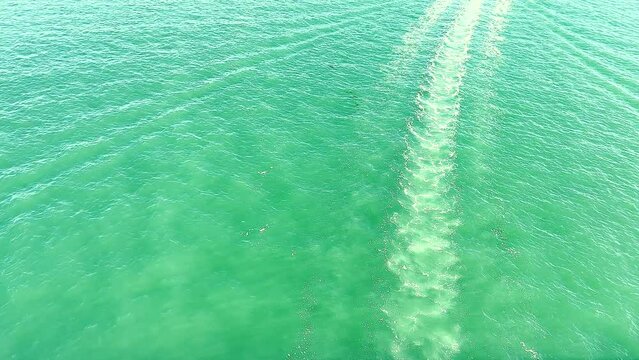 High angle view water wake behind speedboat