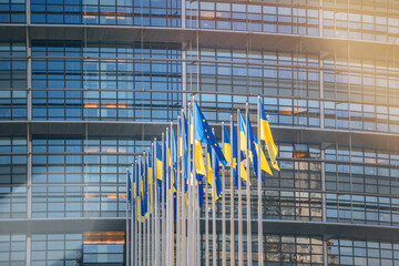 24 Ukrainian flag flies next to the Flag of Europe in front of Parliament building offices. Russia...