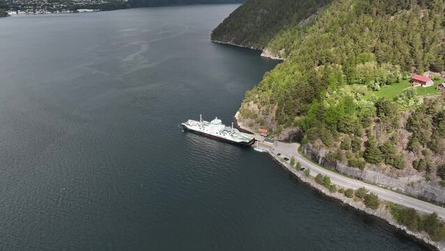Norway Infrastructure - Ferry named Volda leaving port of Liabygda towards Stranda in More and Romsdal - High angle aerial view
