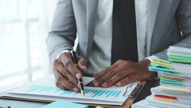 Business adviser analyzing financial figures denoting the progress in the work of the company.