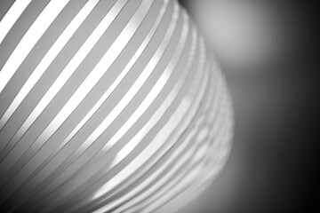 A close-up of a black and white spiral pattern, with striped lines in a perfect circle- an artistic monochrome photograph.
