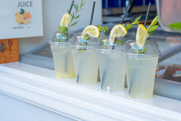 Refreshing mojito drink in single-use plastics cups. Plastic garbage. The concept of the problem of plastic packaging. Ecology and environmental protection