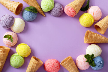 Pastel colored ice cream scoops and cones frame on pastel violet background