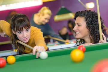 Fototapeta premium two teenage girls playing pool