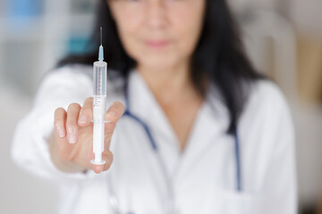 doctor showing hand press syringe