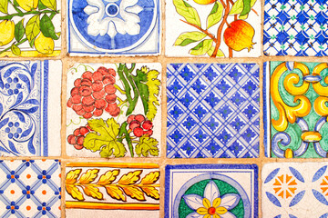 Italian maiolica background, tin-glazed tiles decorated in blue, yellow, green and red colours on a...