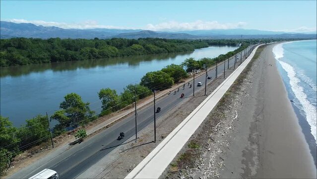 motorcyclist group ride by the beach, drone,  tropical, costa rica