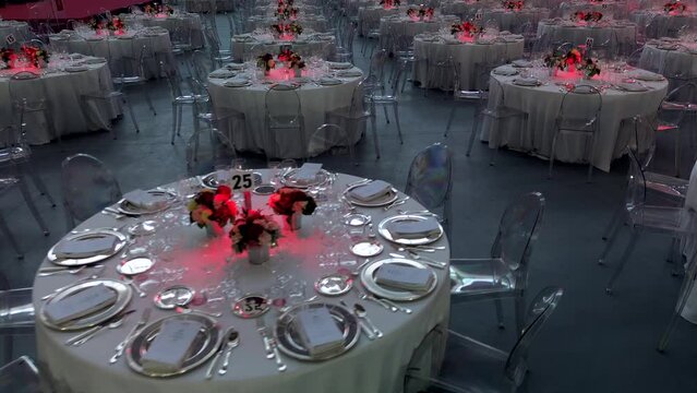 Cinematic image, scenery and flowers at a gala dinner. Luxurious wedding. Banquet arrangement. Table server. Round table. Drone footage. Party Hall