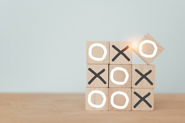 Business marketing strategy planning concept. Wooden block tic tac toe board game including copy...