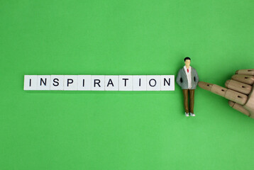 miniature people and letters of the alphabet with the word inspiration. Inspirational concept
