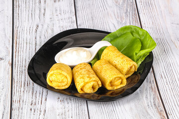 Stuffed pancakes with cream sauce