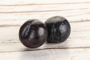 Two ripe sweet black plums