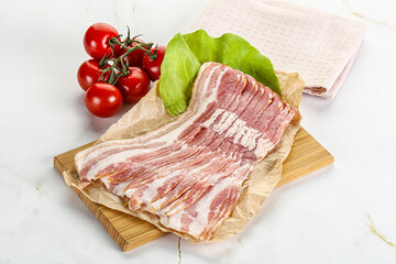 Sliced pork bacon oved board