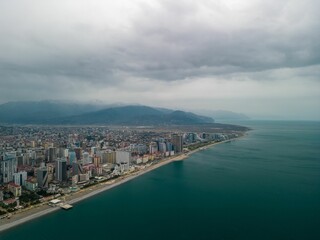 Aerial shot of the coastal town against a clouded sky