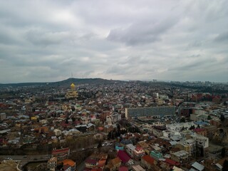 Aerial shot of the ancient church between the small urban houses