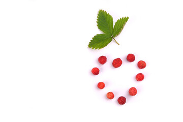 Fragaria berries, wild strawberry heart in a plate isolated on white top view, wild strawberry leaf