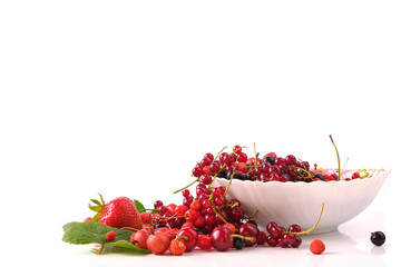various berries in a plate isolated on white, front view, leaves