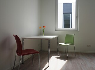Bright, sunlit dining room with warm light pouring in through an open window.