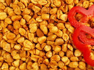 Spicy peeled Peanuts with red Pepper isolated on white Background