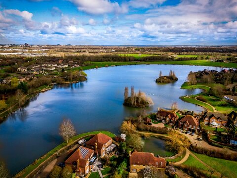 Aerial view of a town situated near a river in Milton Keynes