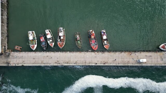 Aerial shot of boats parked by a pier