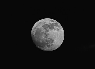 Full moon is illuminated in night sky