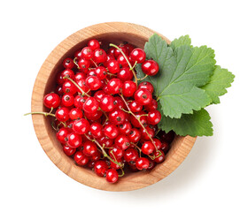 Ripe red currant in a wooden plate on a white background. Top view