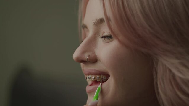 Woman Washing Her Teeth with Dental Braces. Dental Braces brush cleaning process.