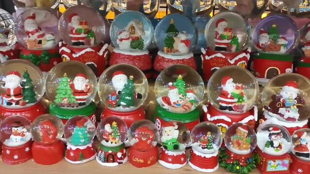 Antalya, Turkey, June 24, 2023. Glass festive transparent Christmas balls with small toys inside