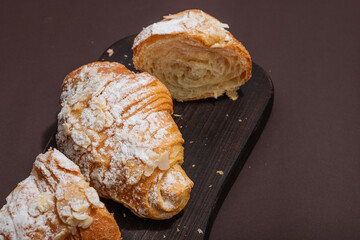 Good morning concept. Fresh croissants with cream filling and almond flakes. Sweet dessert