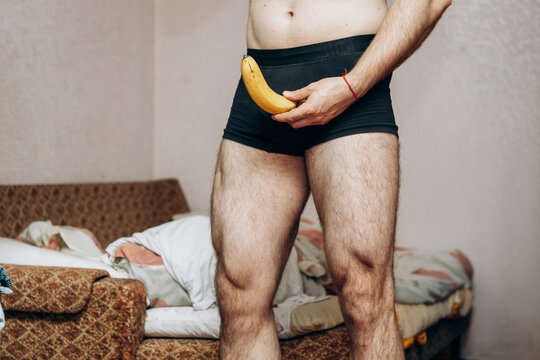 a guy without clothes holds a missing banana in his hand. Erection problem, male health
