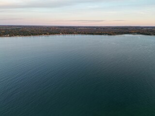 Tranquil lake lies in the background, the stillness of the water with boats moored in the foreground
