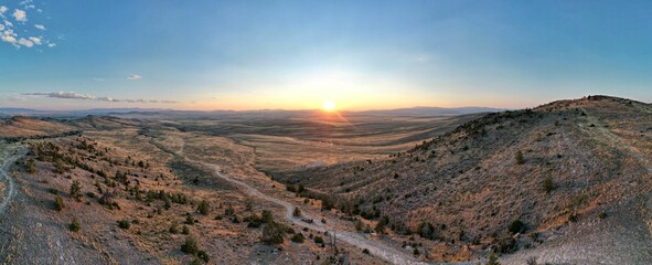 Idyllic view of scenic canyon, showcasing golden hues of sunset illuminating the country road below