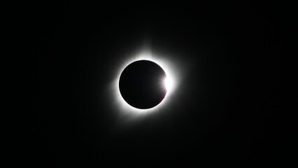 Spectacular view of a white smoke eclipse emerging from the moon in close proximity to the sun - obrazy, fototapety, plakaty