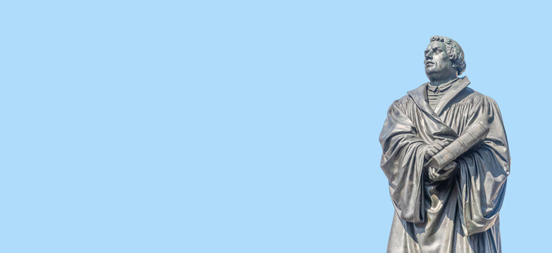 Banner with monument of Martin Luther at Neumarkt square in downtown of Dresden, theologist, composer, priest, who has started Reformation in Catholic Church, with copy space, Germany