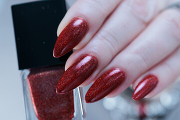 Female hand with long nails and a bright red manicure