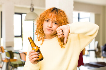 young red hair latin pretty woman having a beer at home