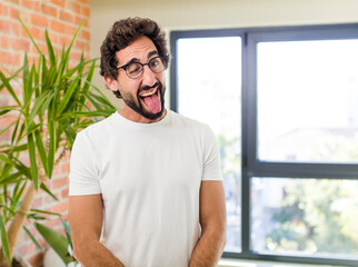 young adult crazy man with expressive pose at a modern house interior