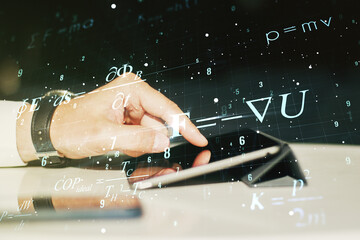 Creative scientific formula hologram and hand working with a digital tablet on background, research concept. Multiexposure