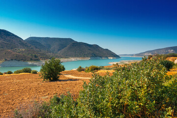 view of Kouris reservoir with lake in mountains of Cyprus - Kannaviou Dam, Limassol, Cyprus, hot summer day