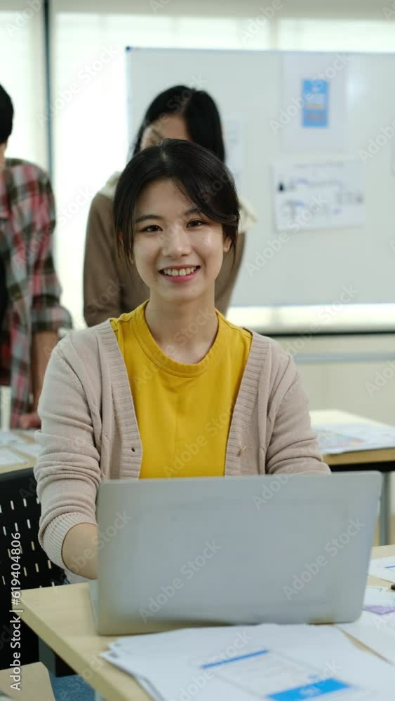Poster young asian woman web developer working on app design and user interface at workstation. slow motion