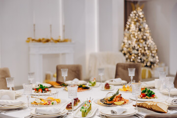 Christmas table setting with delicious dishes.