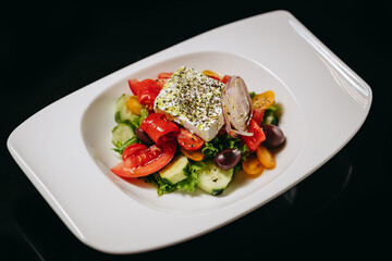 Greek salad with kalamata on a black background